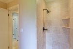 The remodeled guest bathroom features a full shower and vanity